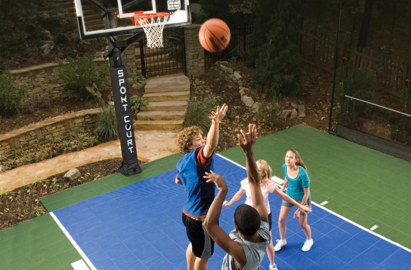 Kids playing basketball in backyard